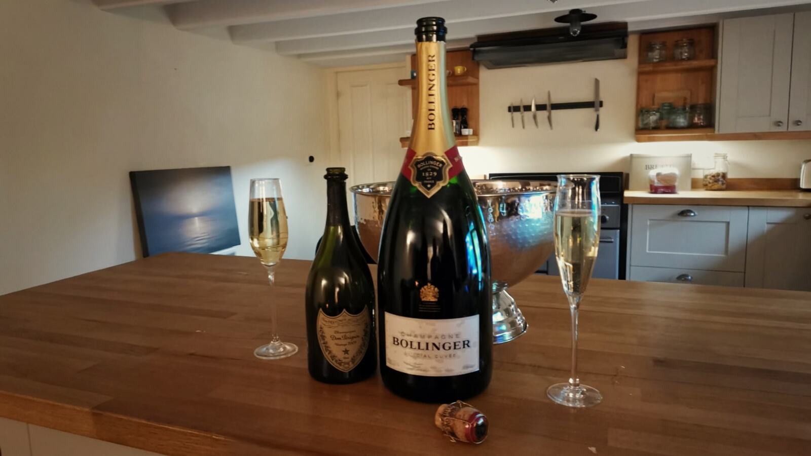 Champagne bottles and glasses set out on a kitchen island, ready for an arrival